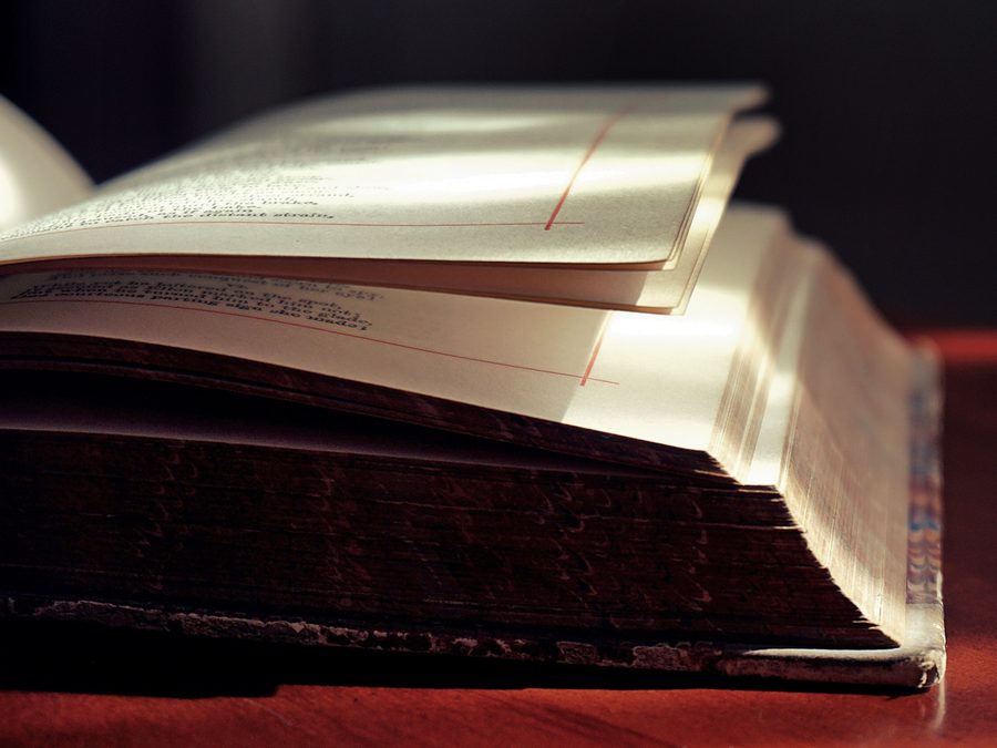 An old bound volume lying open under warm light